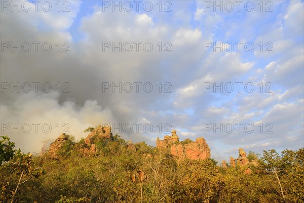 Bizarre rock formation and clouds of smoke during a bushfire