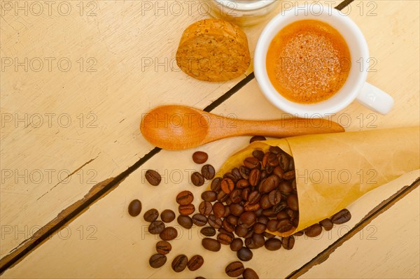 Espresso coffee and beans on a paper cone cornucopia over white background