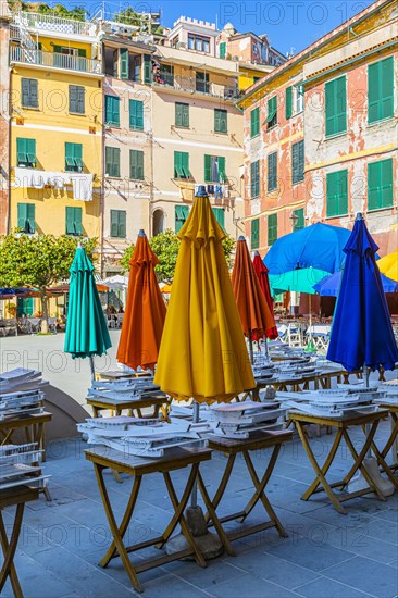 Coloured parasols of a closed restaurant at the main square of Vernazza