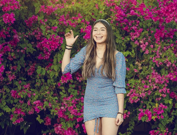 Portrait of a cute latin american girl smiling in a garden