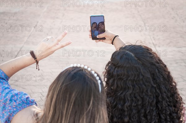 Two pretty girls taking a selfie