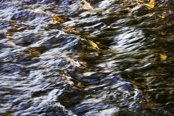 Flowing water with light reflections