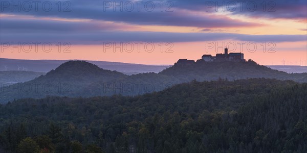 View from the Rennsteig over the Thuringian Forest to Wartburg Castle at dawn in autumn