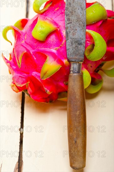 Fresh thai purple dragon fruit over white rustic table