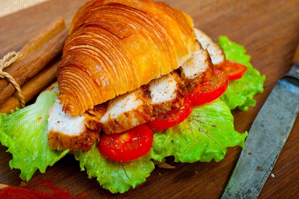 Savory croissant brioche bread with chicken breast and vegetable rustic style