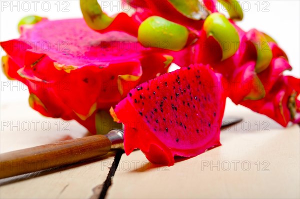 Fresh thai purple dragon fruit over white rustic table