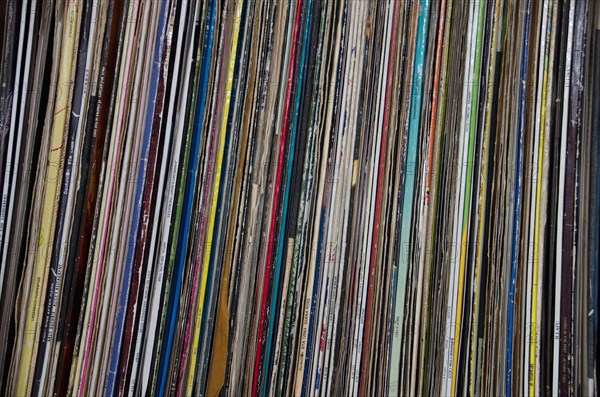 Old long-playing records stand on a shelf