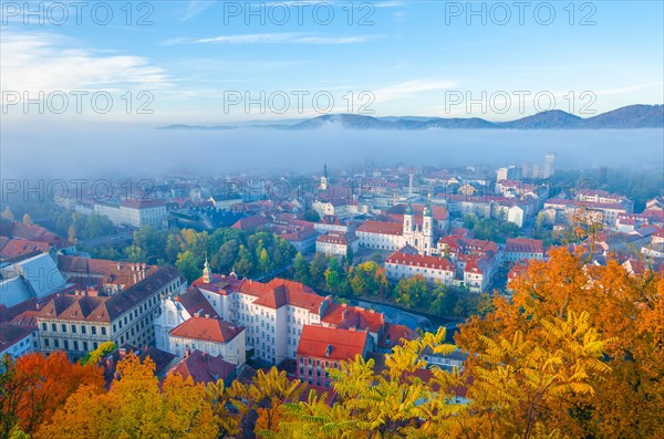 Cityscape of Graz with Mur river and Mariahilfer church