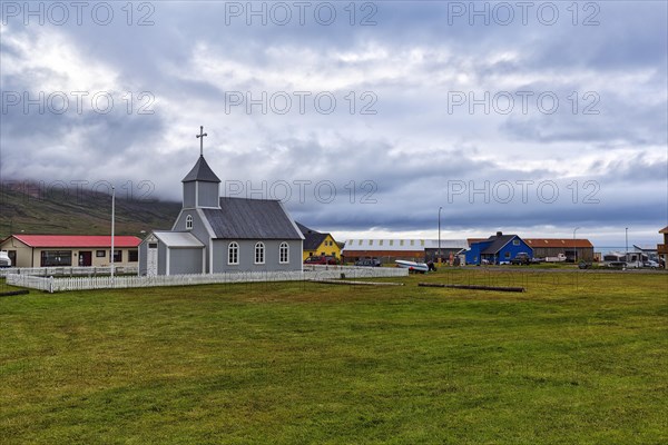 Grey wooden church and dwellings in Bakkagerdi village