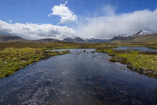 River in moor landscape with cloudy sky