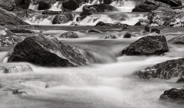 Mountain stream flows over moss-covered stones