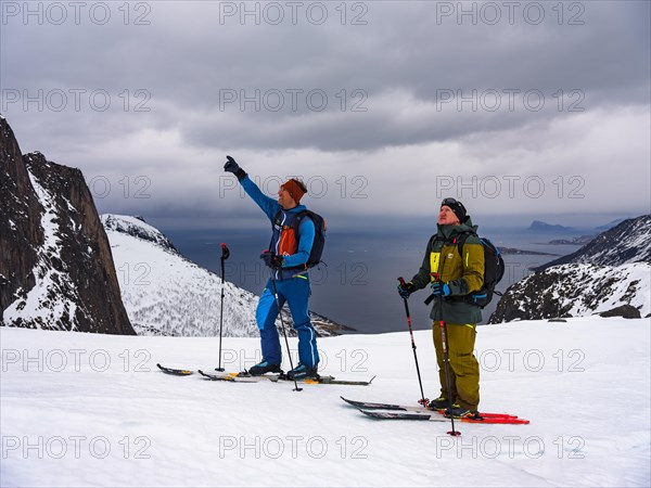 Mountain guide shows his guest the way ahead