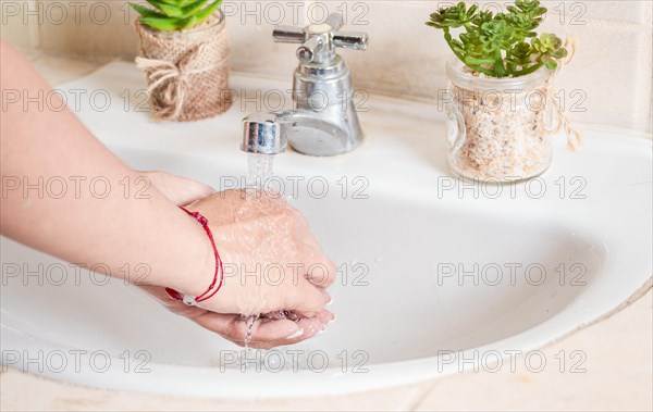 Close up of a person washing their hands with soap