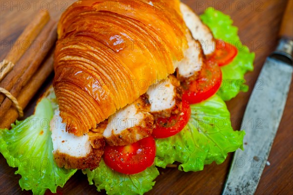 Savory croissant brioche bread with chicken breast and vegetable rustic style