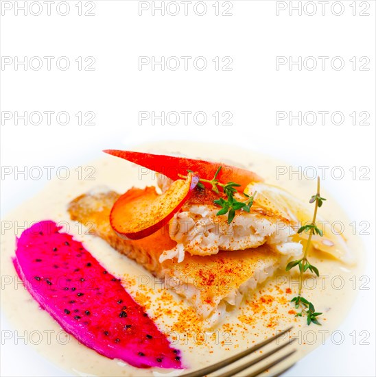 Sea bream orata fillet butter pan fried with fresh peach prune and dragonfruit slices thyme on top