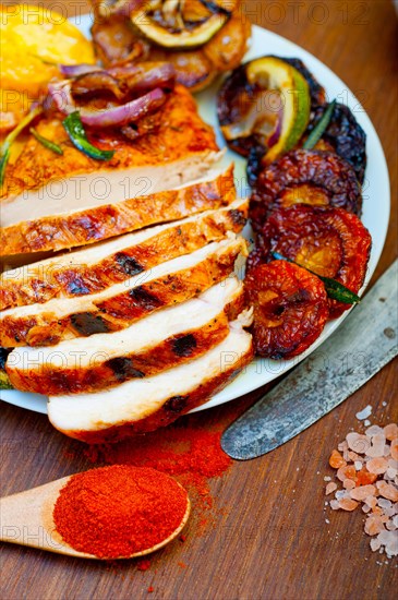 Roasted grilled BBQ chicken breast with herbs and spices rustic style