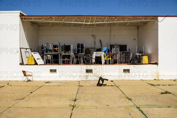 Pattern of messy chairs and tables in outdoor storage in Farol island