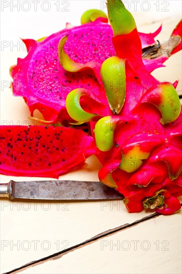 Fresh thai purple dragon fruit over white rustic table