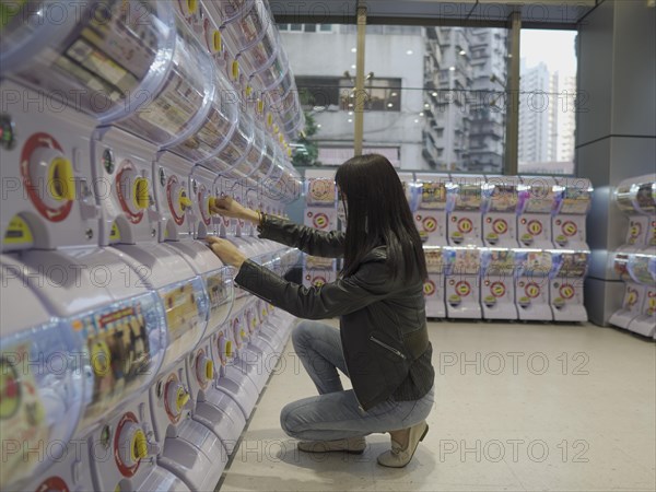 Girl at toy vending machine in Macau