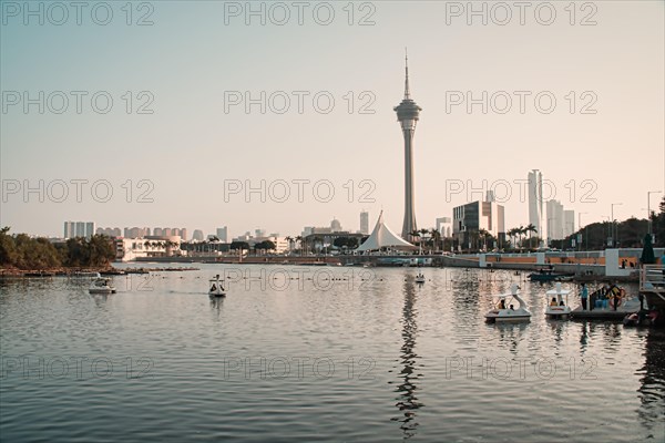 Swan boats near Macau Tower by the sea in Macau