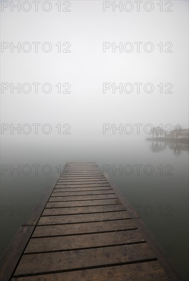 Abandoned bathing jetty in the morning mist