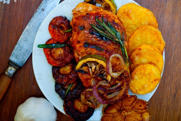 Roasted grilled BBQ chicken breast with herbs and spices rustic style