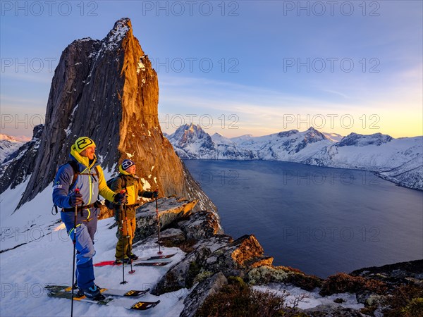 Two ski mountaineers on the steep mountain Segla