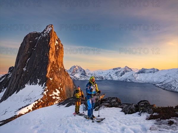 Two ski mountaineers at the Ascend of the steep mountain Segla