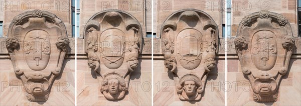 Four heraldic cartouches on the main facade of the courthouse