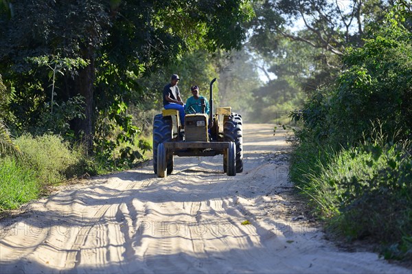 Tractor driving on sand road