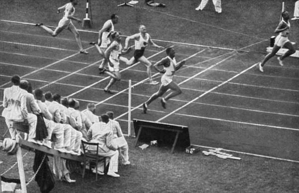 Jesse Owens tears the finish tape in the 100 m