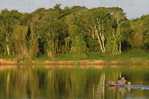 Boat with anglers on the Rio Sao Lourenco in the evening light