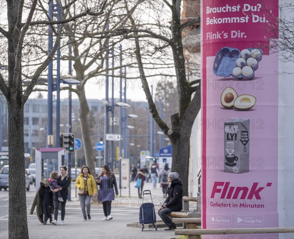 Advertisement of the delivery service Flink on an advertising pillar