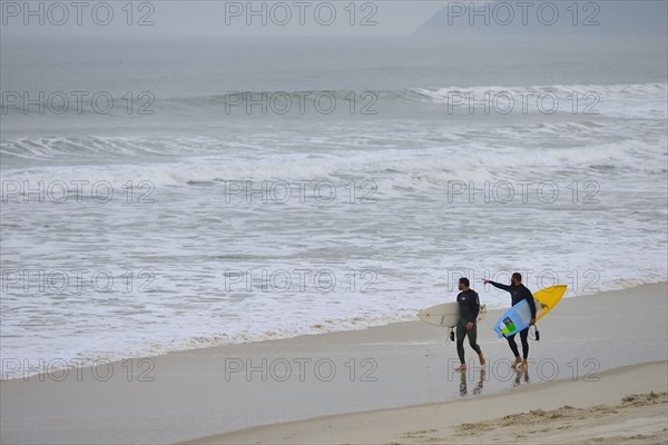 Two surfers with surfboard on Praia de Mocambique