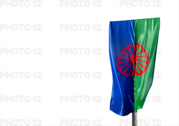 Eine Roma und Sintiflagge weht im Wind mit weissem Hintergrund