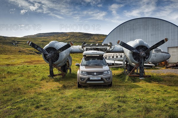 Tourist parks in front of United States Navy aircraft wreck