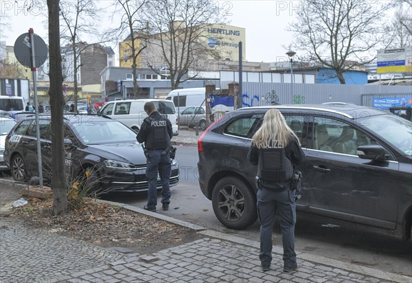 Police officers writing parking tickets