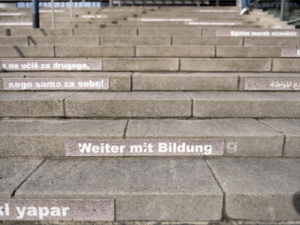 Stairway steps with slogans on the subject of education in several languages