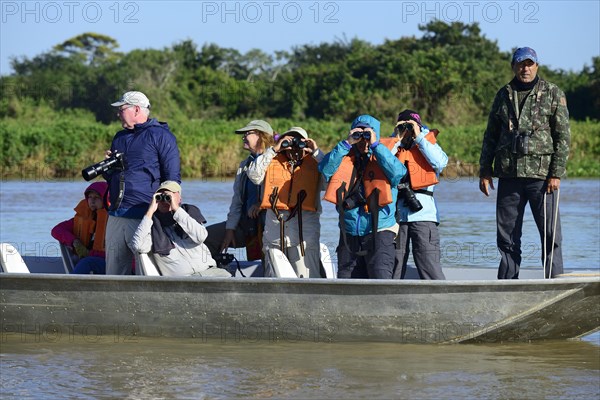 Tourists in a motorboat watching wildlife