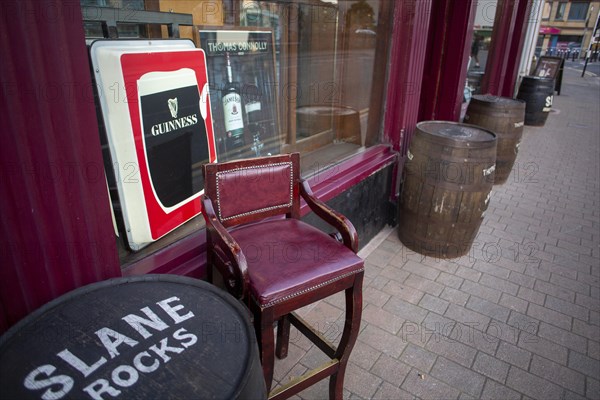 Guinness stout sign outside a Sligo pub with beer barrels in front. Sligo