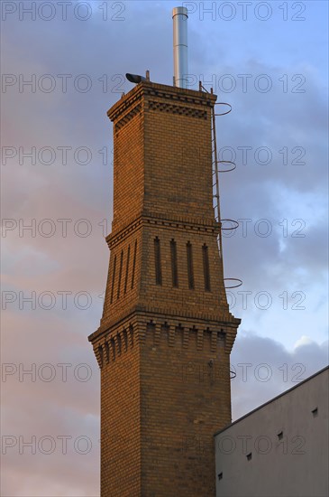 Old brick factory chimney in the evening light