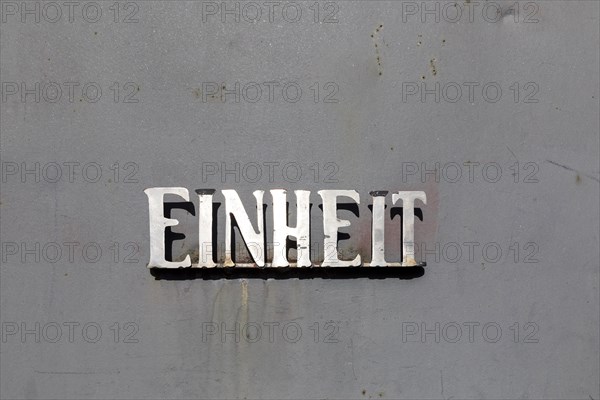 Unit lettering made of metal on a metal surface