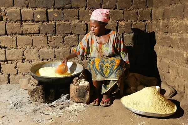 Woman preparing maniok flakes in Bamenda, Cameroon