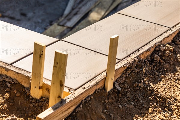 Fresh pool coping cement drying within wood framing