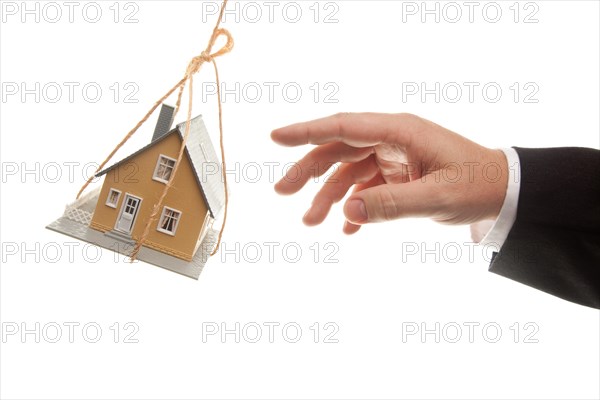 Swinging house and business man's hand reaching or pushing isolated on a white background