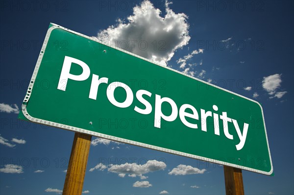 Prosperity green road sign with dramatic clouds and sky