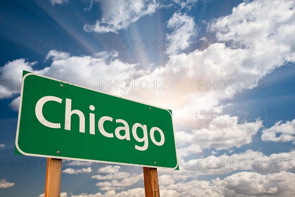 Chicago green road sign over dramatic clouds and sky