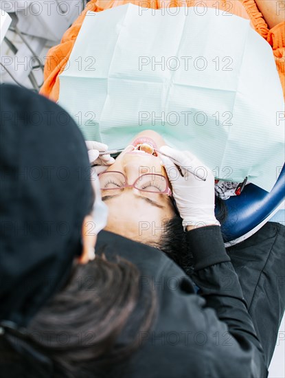 View back of dentist with patient