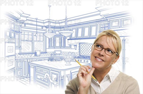 Daydreaming woman with pencil over custom kitchen design drawing isolated on white