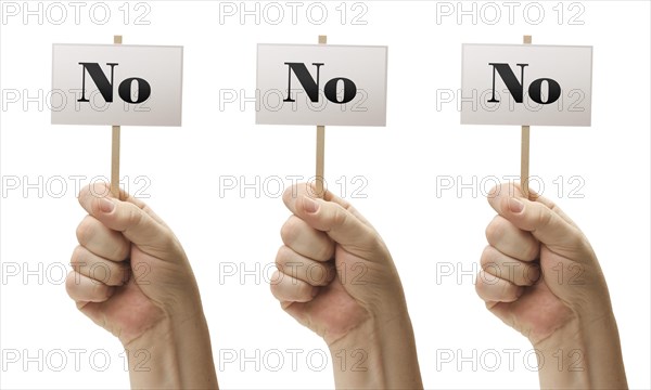 Three signs in male fists saying no